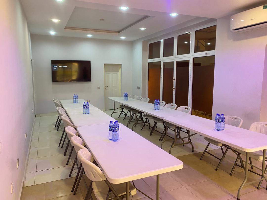 Conference Room wide view showing full seating capacity and presentation screen